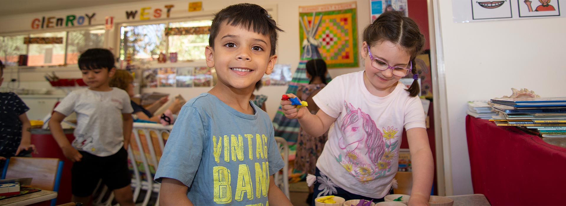 Cute smiling boy playing with friends at Glenroy West Kindergarten